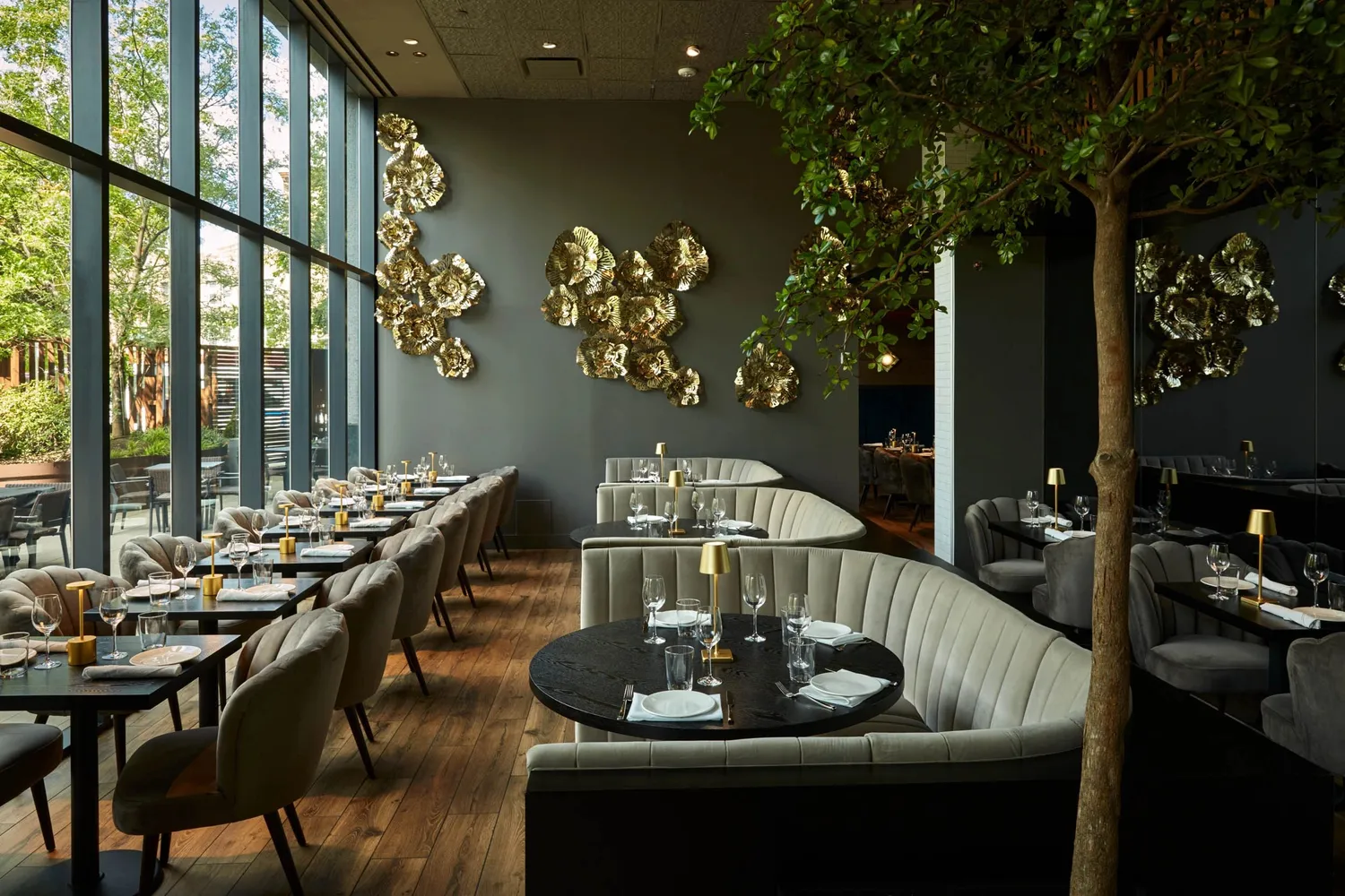 A stylish restaurant with a well-stocked bar and tables ready for patrons to dine and relax.
